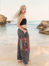 Side view of boho pants on beach rocks