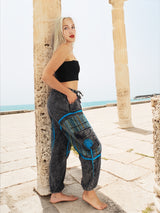 Unisex boho yoga pants with blue spiral near columns