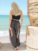 Back view of gray boho pants with rainbow details