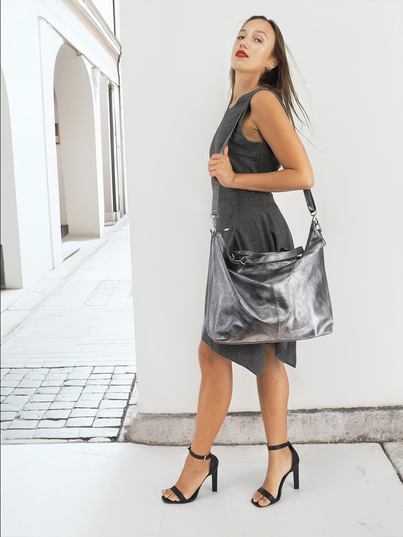 Model with metallic silver handbag, modern fashion