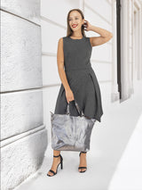 Model smiling with metallic silver handbag, elegant