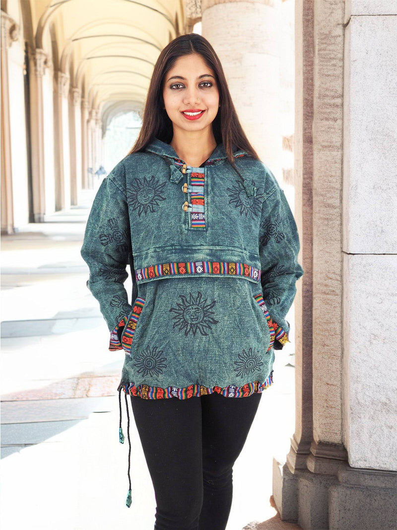 a woman standing in a hallway wearing a green jacket