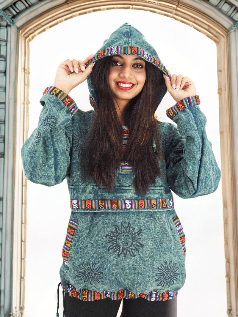 a woman in a green hoodie is posing for a picture