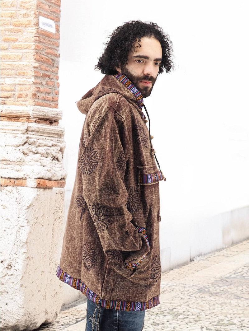 a man standing on a sidewalk wearing a jacket