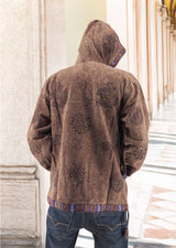 a man in a brown jacket is standing outside