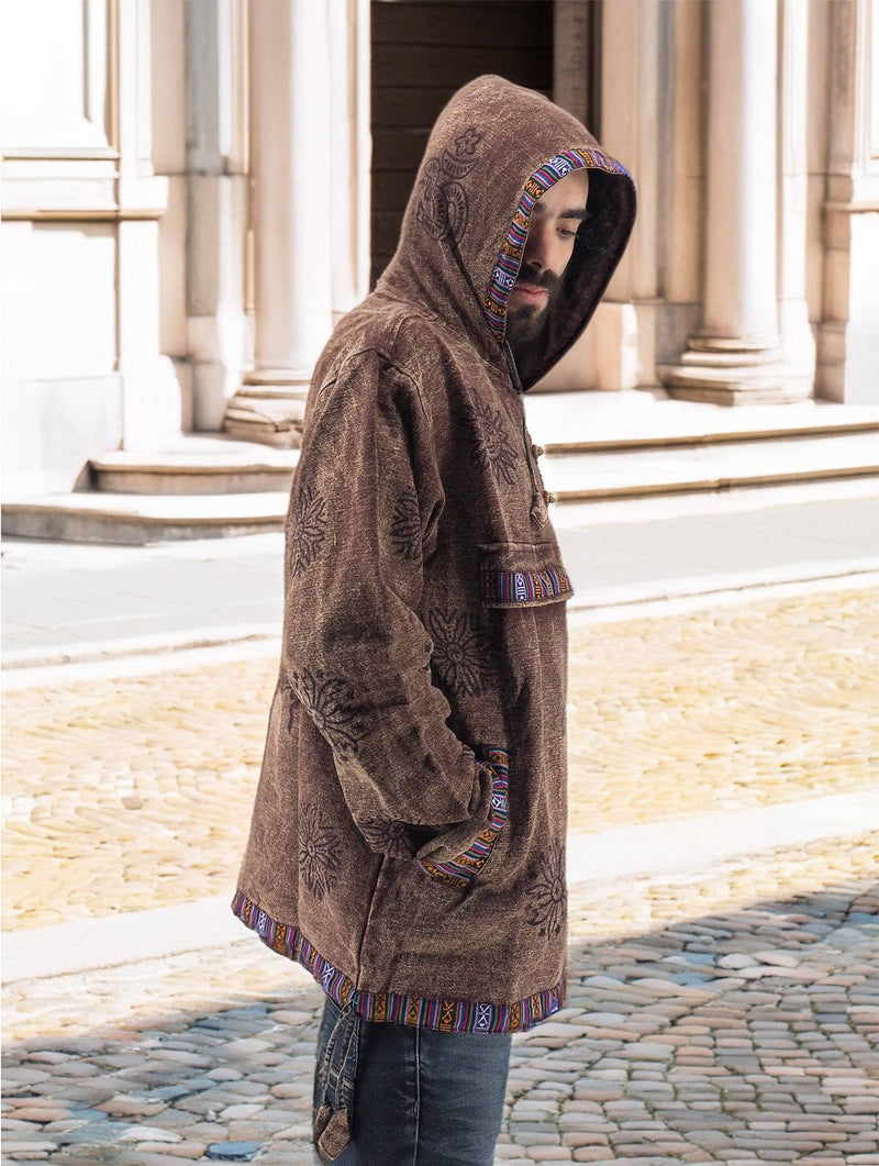 a man in a brown jacket is standing on a cobblestone street