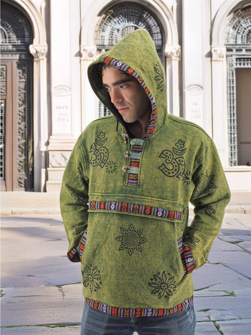 a man in a green hoodie standing on a sidewalk