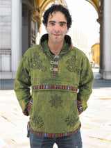 a man standing in front of a building wearing a green jacket