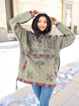 a woman standing on a sidewalk with her hands on her head