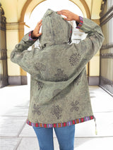 a woman wearing a jacket with a hoodie on