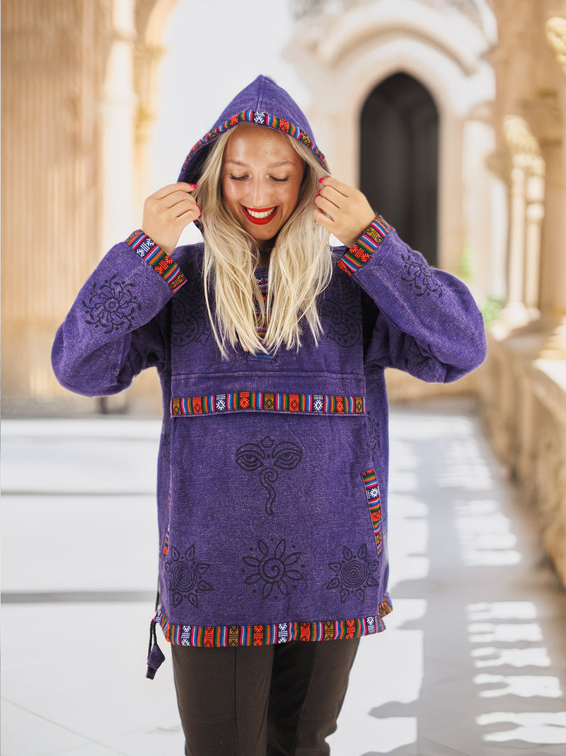 a woman is walking down a sidewalk wearing a purple coat