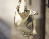 Close-up of metallic gold leather handbag