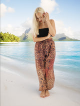 a woman standing on a beach next to the ocean