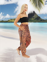 a woman standing on a beach next to a palm tree