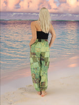 a woman standing on a beach looking at the ocean