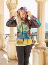 Colorful boho-style patchwork hoodie against architectural background