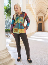 Colorful handmade patchwork boho hoodie, bohemian style clothing, woman standing in front of historic architecture