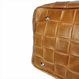 Interior view of brown woven leather handbag with compartments